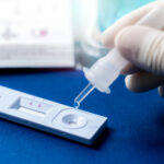 Hand holding sample tube and drops in the test device of covid 19 antigen self test. Antigen test kit for detection of coronavirus infection. Rapid antigen test. Coronavirus diagnosis. Medical device.