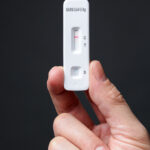 Hand holding a negative antigen rapid test
